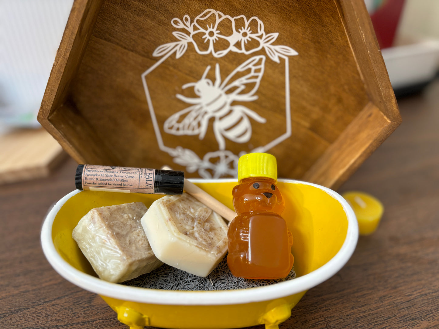 Honey, lip balm, small soap pieces in a yellow bathtub.
