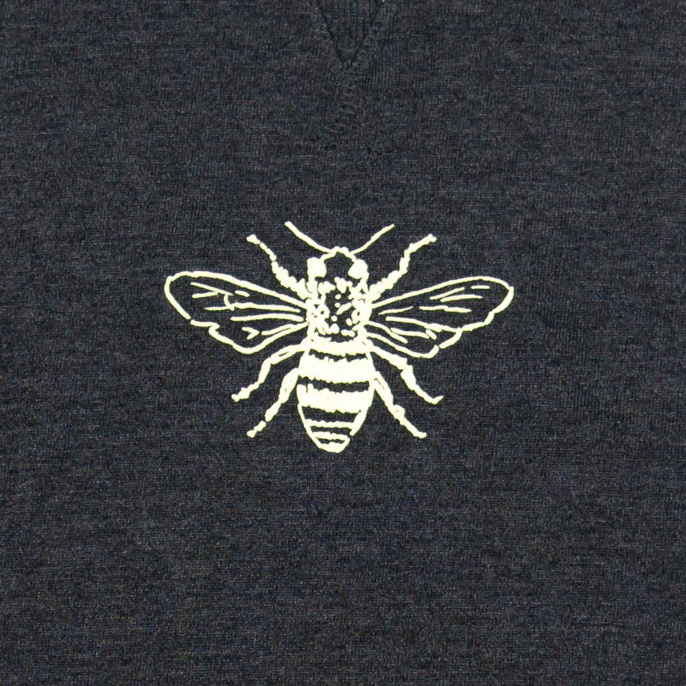 Bee on gray pullover.