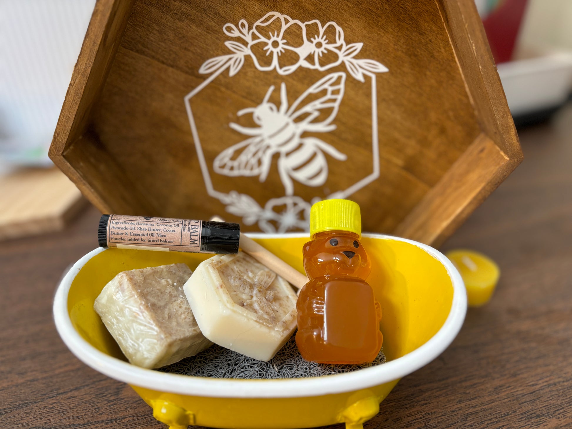 Honey, lip balm, small soap pieces in a yellow bathtub. 