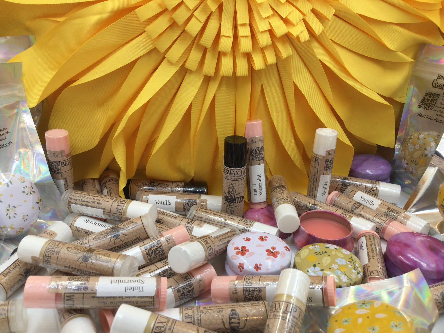 A lot of lip balm with yellow back ground