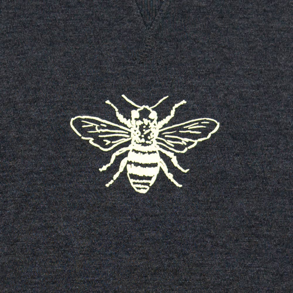 Bee on gray pullover.