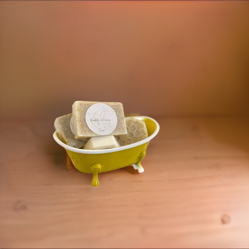 Toy size yellow bathtub with bee themed soap display..